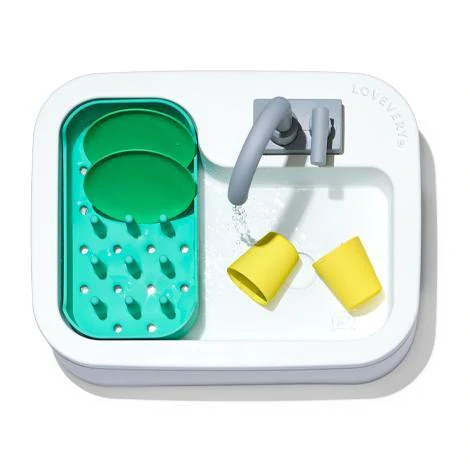 Lovevery Super Sustainable Sink with green plates, yellow cups and a grey faucet