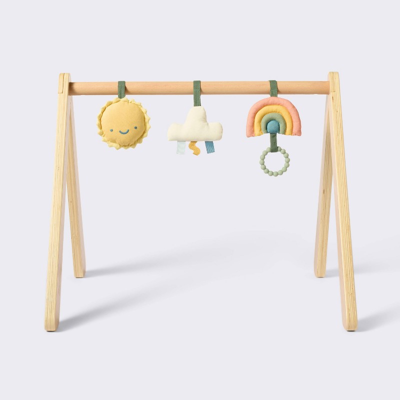 Cloud Island wooden play gym with three hanging toys